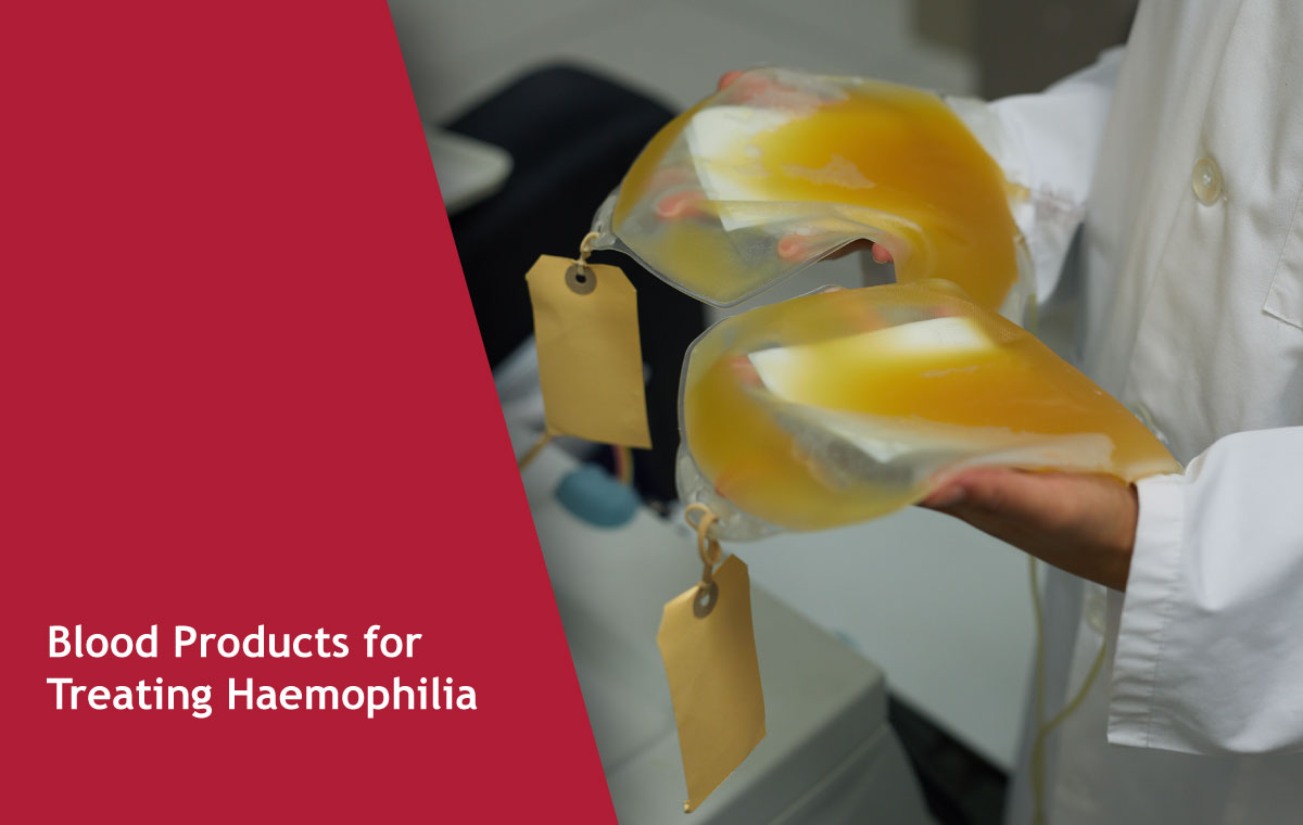 Healthcare worker holds bags of labelled blood products used to treat haemophilia.