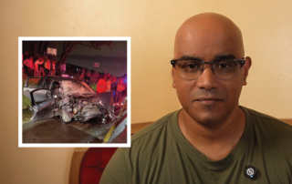 Portrait of a bald man wearing glasses indoors, with a nighttime car-crash scene inset showing a severely damaged vehicle and bystanders nearby, suggesting a news/photo collage.