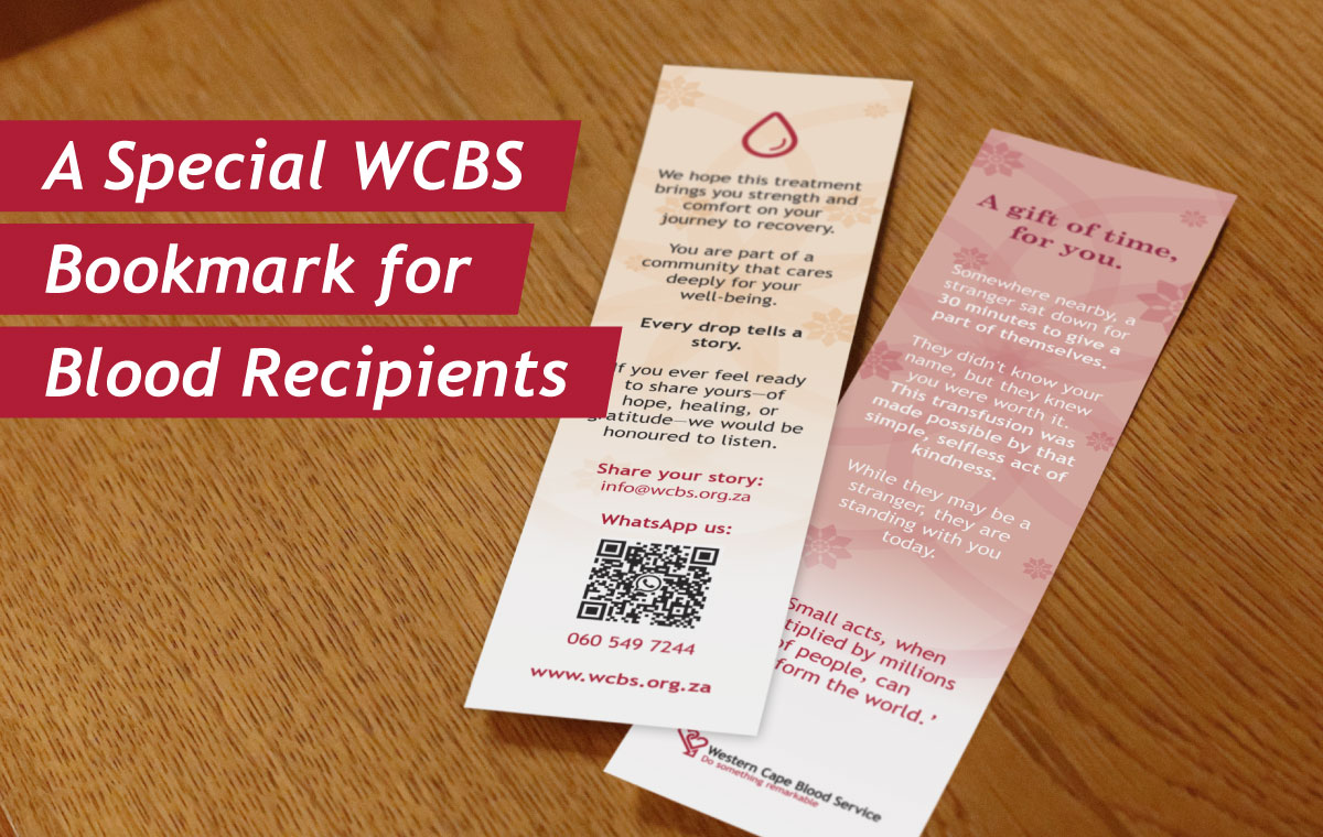 Bookmark on a wooden table with red ribbons reading 'A Special WCBS Bookmark for Blood Recipients' and two pale pink/cream cards with text and a QR code, tilted diagonally.